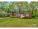 Quaint single story brick home with a carport and beautiful landscaping at 252 Stamey Farm Rd, Statesville, NC 28677