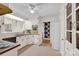 Functional kitchen featuring vintage appliances, white cabinets, and ample natural light from surrounding windows at 252 Stamey Farm Rd, Statesville, NC 28677