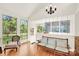 Bright living area with a wooden sofa, large windows with a view of the yard and garden at 252 Stamey Farm Rd, Statesville, NC 28677
