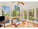 Sunroom with hardwood floors, bright natural light, and views of the wooded backyard at 252 Stamey Farm Rd, Statesville, NC 28677