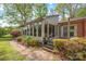 Exterior of a bright sunroom addition with large windows and a small deck at 252 Stamey Farm Rd, Statesville, NC 28677