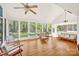 Bright sunroom featuring hardwood floors, a vaulted ceiling, and multiple windows showcasing the surrounding greenery at 252 Stamey Farm Rd, Statesville, NC 28677