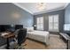 Bedroom with a comfortable bed, shuttered windows, and a dedicated workspace at 2934 Selwyn Ave, Charlotte, NC 28209