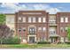 Entrance to brick condo building at Selwyn Terrace with architectural details and professional landscaping at 2934 Selwyn Ave, Charlotte, NC 28209