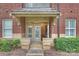 Charming entrance with a covered porch, brick accents and landscaped surroundings at 2934 Selwyn Ave, Charlotte, NC 28209
