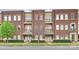 Close up of condo building exterior at Selwyn Terrace with architectural detail, covered entrances, and landscaping at 2934 Selwyn Ave, Charlotte, NC 28209