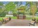 Community brick patio with stainless steel grill and benches, surrounded by landscaping at 2934 Selwyn Ave, Charlotte, NC 28209