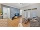 Inviting living room with hardwood floors, a gray accent wall, and access to the balcony at 2934 Selwyn Ave, Charlotte, NC 28209
