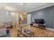 Open-concept living room with hardwood floors, a dining area and an open view to the kitchen at 2934 Selwyn Ave, Charlotte, NC 28209