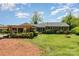 Expansive backyard featuring mature trees, manicured lawn, large patio area, and a covered parking area at 3000 Imperial Dr, Gastonia, NC 28054