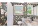 Charming full bathroom featuring floral wallpaper, window and vanity with granite counter and white fixtures at 3000 Imperial Dr, Gastonia, NC 28054