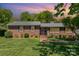 Charming brick home with manicured lawn, inviting walkway, and mature trees showcasing curb appeal at 3000 Imperial Dr, Gastonia, NC 28054