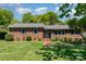 Classic brick home with lush green lawn, brick walkway, and mature trees highlighting the inviting facade at 3000 Imperial Dr, Gastonia, NC 28054
