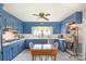 This eat-in kitchen features custom blue cabinetry, white countertops, stainless appliances and tile floors at 3000 Imperial Dr, Gastonia, NC 28054