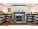 Cozy living room featuring a fireplace with bookshelves and plants at 3000 Imperial Dr, Gastonia, NC 28054