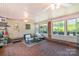This sunroom features brick floors, lots of natural light, and a ceiling fan at 3000 Imperial Dr, Gastonia, NC 28054