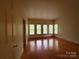 Large bedroom with three windows and hardwood flooring at 3011 Lakewood Edge Dr, Charlotte, NC 28269