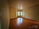 Large bedroom with hardwood floors and a bay of windows at 3011 Lakewood Edge Dr, Charlotte, NC 28269