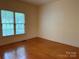 Bedroom with hardwood floors and windows overlooking the yard at 3011 Lakewood Edge Dr, Charlotte, NC 28269