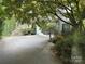 Long driveway and attached garage with landscaped yard and mature trees at 3011 Lakewood Edge Dr, Charlotte, NC 28269