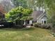 Charming one-story home with beautiful landscaping and mature trees at 3011 Lakewood Edge Dr, Charlotte, NC 28269