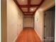 Hallway with wood flooring, wood trim ceiling, and white doors at 3011 Lakewood Edge Dr, Charlotte, NC 28269