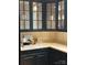 The stylish kitchen is enhanced by dark cabinets and light counter tops and glass front cabinets at 3011 Lakewood Edge Dr, Charlotte, NC 28269