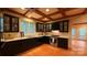 Charming kitchen with dark cabinets, hardwood floors, and a window with a view of nature at 3011 Lakewood Edge Dr, Charlotte, NC 28269
