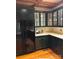 This kitchen includes dark cabinets, light countertops, and black appliances for a sleek look at 3011 Lakewood Edge Dr, Charlotte, NC 28269