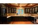 Well-appointed kitchen featuring dark cabinetry, hardwood floors, and stainless steel appliances at 3011 Lakewood Edge Dr, Charlotte, NC 28269
