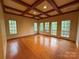 The living room offers wood floors, large windows, coffered ceilings and great views at 3011 Lakewood Edge Dr, Charlotte, NC 28269