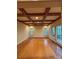 Large living room with warm wooden floors and coffered ceiling and beautiful views at 3011 Lakewood Edge Dr, Charlotte, NC 28269