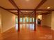 Large living room with hardwood floors, exposed beams, and a cozy fireplace at 3011 Lakewood Edge Dr, Charlotte, NC 28269