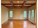 Spacious living room with hardwood floors, coffered ceiling and ample natural light at 3011 Lakewood Edge Dr, Charlotte, NC 28269