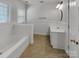 Well-lit bathroom featuring a tub, vanity, and tile flooring at 3114 Parker Green Trl, Charlotte, NC 28269
