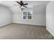 Comfortable bedroom with plush carpet, a ceiling fan, and a large window for natural light at 3114 Parker Green Trl, Charlotte, NC 28269
