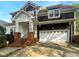 Charming two-story home featuring a brick staircase leading to the covered porch and a two-car garage at 3114 Parker Green Trl, Charlotte, NC 28269