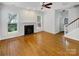 Bright living room with hardwood floors, fireplace, and large windows allowing ample natural light at 3114 Parker Green Trl, Charlotte, NC 28269