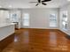 Open-concept living area connecting kitchen and living space, filled with natural light and hardwood floors at 3114 Parker Green Trl, Charlotte, NC 28269