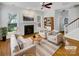Bright living room featuring a fireplace, hardwood floors, ceiling fan and stylish furniture at 3114 Parker Green Trl, Charlotte, NC 28269