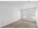 A carpeted bedroom with a window at 3214 Park South Station Blvd, Charlotte, NC 28210