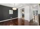 This dining room features hardwood floors, crown molding, modern chandelier, and dark accent wall at 3214 Park South Station Blvd, Charlotte, NC 28210