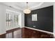 This elegant dining room features hardwood floors, crown molding, a modern chandelier, and plenty of natural light at 3214 Park South Station Blvd, Charlotte, NC 28210