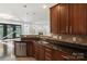 Features of the kitchen include stainless appliances, wood cabinets, a sink, and dark countertops at 3214 Park South Station Blvd, Charlotte, NC 28210