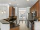 Bright kitchen with stainless steel appliances, dark counter tops, wood cabinets, and an adjacent living area at 3214 Park South Station Blvd, Charlotte, NC 28210