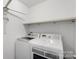 A laundry room with a washer, dryer and shelving at 3214 Park South Station Blvd, Charlotte, NC 28210