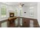 Bright, open living room with a stone fireplace, dark hardwood floors, and many windows at 3214 Park South Station Blvd, Charlotte, NC 28210