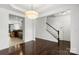 Open-concept living room with hardwood floors, view of stairs, and dining area with stainless steel kitchen appliances at 3214 Park South Station Blvd, Charlotte, NC 28210
