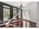 Living area featuring hardwood floors, a ceiling fan, and access to the backyard at 3214 Park South Station Blvd, Charlotte, NC 28210