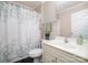 Bathroom featuring a sink, toilet, and shower with a leafy green shower curtain at 3248 Park South Station Blvd, Charlotte, NC 28210